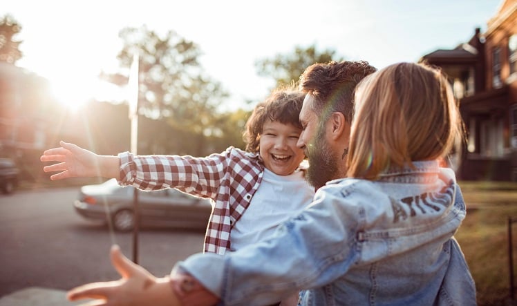 A family smiling and ready to hug.